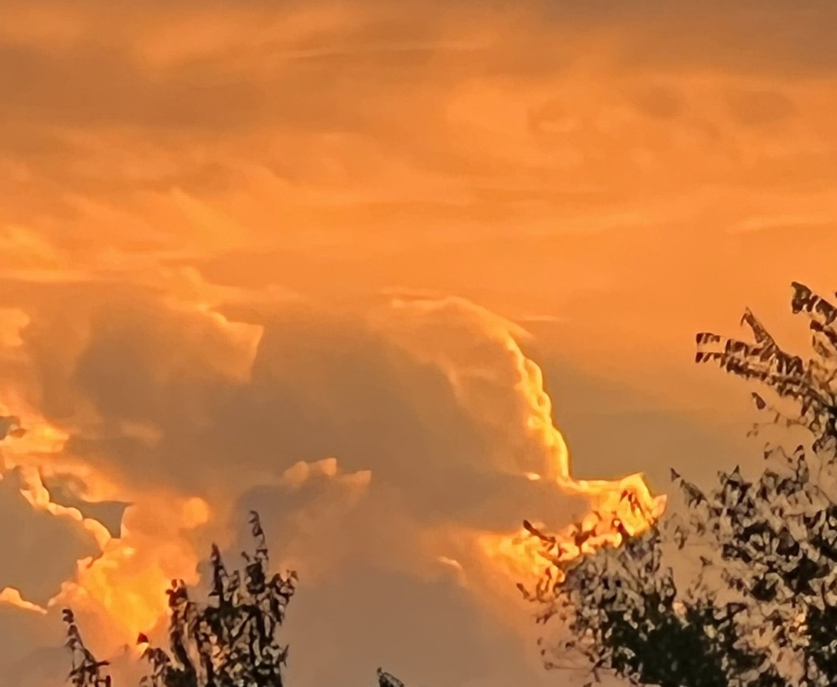 Huge red clouds at sunset captioned Power